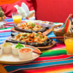 mexican chicken fajitas with sauces on a table